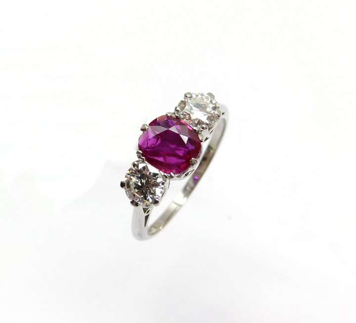 Ruby and diamond three stone ring centred by a 1.00ct cushion shaped Burma ruby